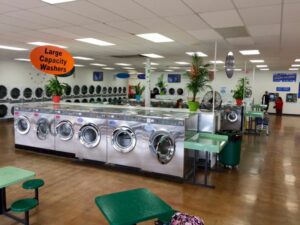 Washers and dryers inside of a laundromat.